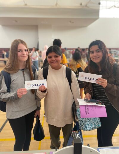 a group of girls holding signs