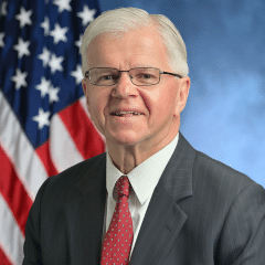 Fred Thiele Headshot Thiele Flag A picture of a man with the American flag in the background